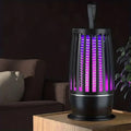 Black purifier with purple light on a wooden surface, dark background